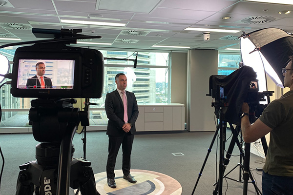 Man standing for interview with camera and lighting