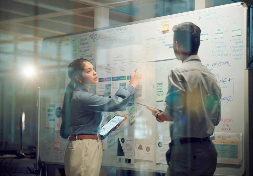 Marketing manager and video producer discussing a corporate video budget and production plan.